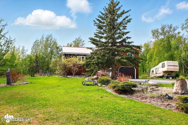 650 N Esty Dr, Palmer, AK 99645 - view of grassy yard with asphalt driveway and a garage
