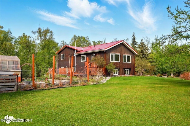 650 N Esty Dr, Palmer, AK 99645 - back of house with metal roof and a vegetable garden