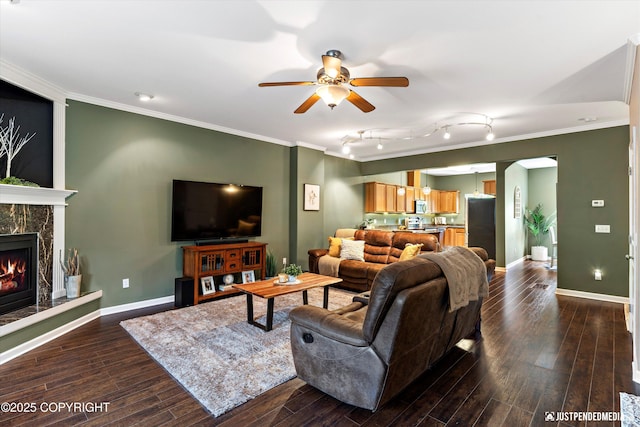 12621 Bona Kim Loop # 4, Anchorage, AK 99515 - living room with ceiling fan, dark wood-style floors, ornamental molding, baseboards, and a fireplace