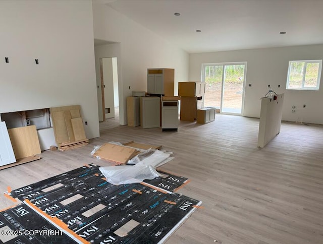 6940 W Werner Dr, Wasilla, AK 99654 - living area featuring light wood-style floors, healthy amount of natural light, and high vaulted ceiling
