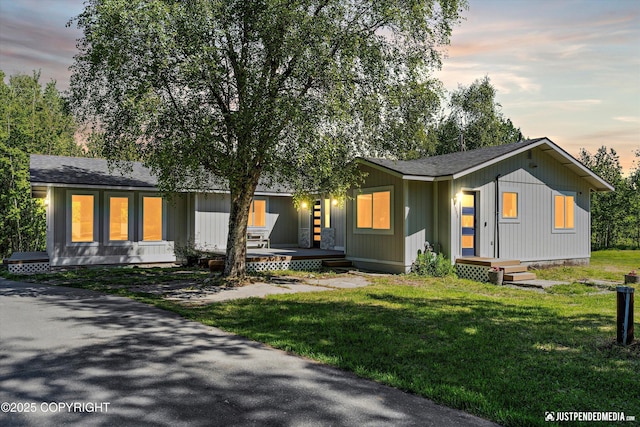 1551 S Oat St, Wasilla, AK 99654 - view of front of home with a front lawn, roof with shingles, and covered porch