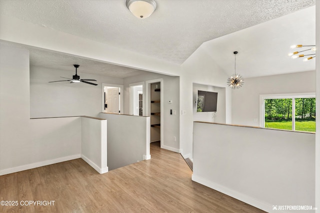 1551 S Oat St, Wasilla, AK 99654 - unfurnished room featuring baseboards, wood finished floors, a textured ceiling, lofted ceiling, and a ceiling fan