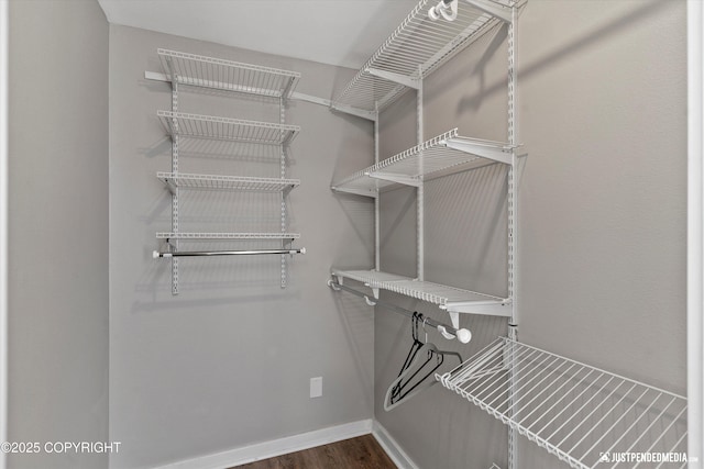 1551 S Oat St, Wasilla, AK 99654 - walk in closet featuring dark wood-type flooring