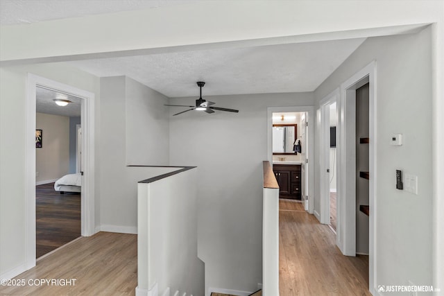 1551 S Oat St, Wasilla, AK 99654 - hall with an upstairs landing, light wood finished floors, and baseboards