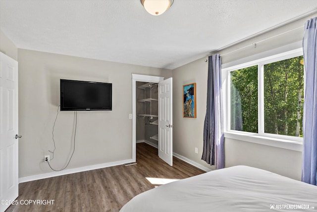 1551 S Oat St, Wasilla, AK 99654 - bedroom featuring wood finished floors, baseboards, a spacious closet, and a closet