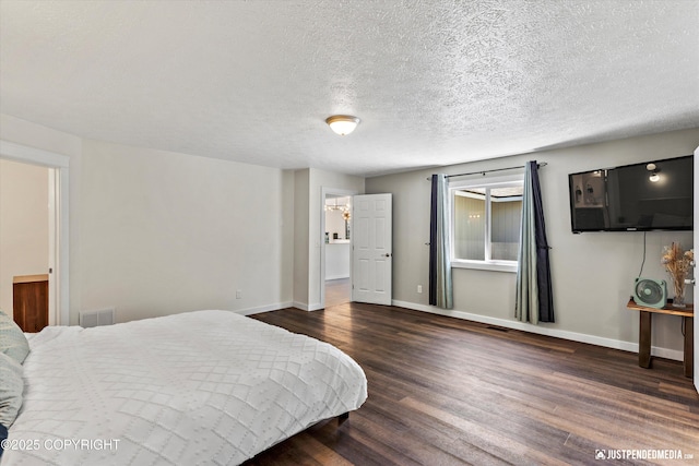 1551 S Oat St, Wasilla, AK 99654 - bedroom with dark wood finished floors, baseboards, and a textured ceiling