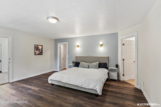 1551 S Oat St, Wasilla, AK 99654 - bedroom featuring dark wood-style flooring, baseboards, and a textured ceiling