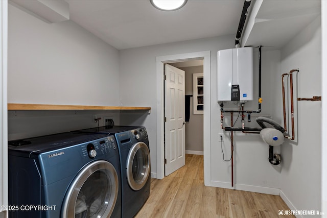 1551 S Oat St, Wasilla, AK 99654 - laundry area with tankless water heater, independent washer and dryer, baseboards, and light wood finished floors