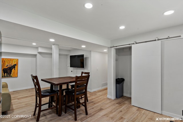 1551 S Oat St, Wasilla, AK 99654 - dining area with light wood finished floors, a barn door, baseboards, and recessed lighting