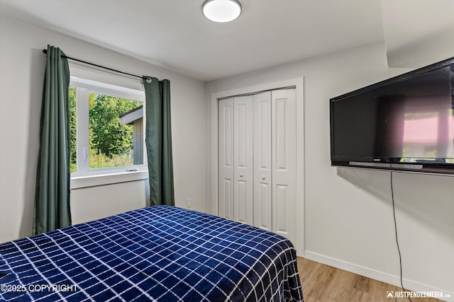 1551 S Oat St, Wasilla, AK 99654 - bedroom featuring wood finished floors, a closet, and baseboards