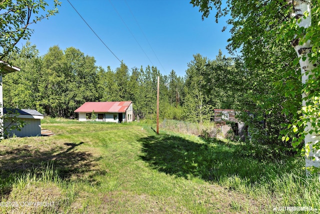 1551 S Oat St, Wasilla, AK 99654 - view of grassy yard with a wooded view