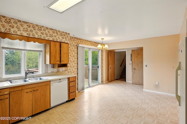 7101 Omalley Rd, Anchorage, AK 99507 - kitchen featuring a sink, dishwasher, a chandelier, light countertops, and baseboards