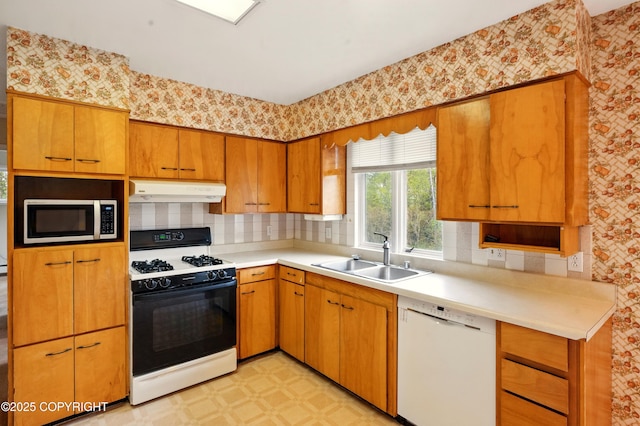 7101 Omalley Rd, Anchorage, AK 99507 - kitchen featuring dishwasher, gas range, under cabinet range hood, stainless steel microwave, and a sink