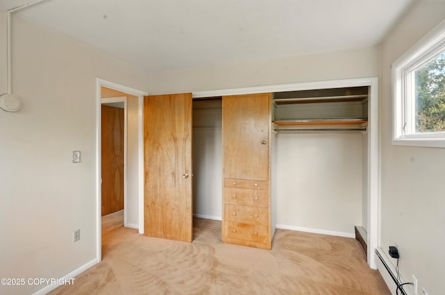 7101 Omalley Rd, Anchorage, AK 99507 - unfurnished bedroom featuring carpet flooring, a closet, a baseboard radiator, and baseboards