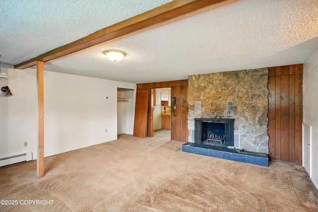 7101 Omalley Rd, Anchorage, AK 99507 - unfurnished living room with carpet, wooden walls, a textured ceiling, a stone fireplace, and a baseboard heating unit