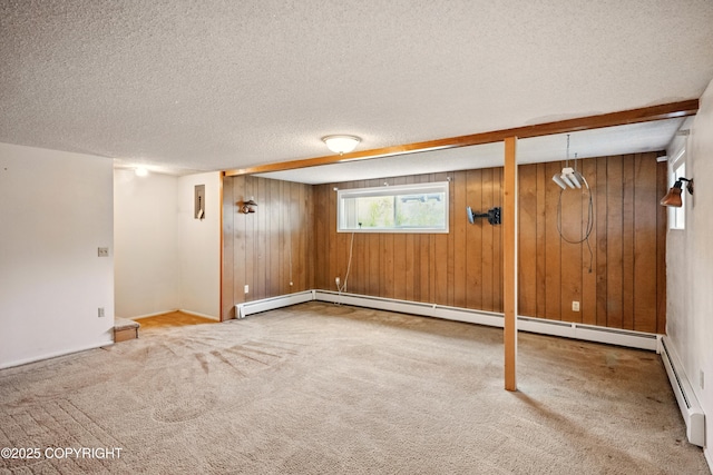 7101 Omalley Rd, Anchorage, AK 99507 - basement featuring wood walls, a textured ceiling, carpet, and baseboard heating