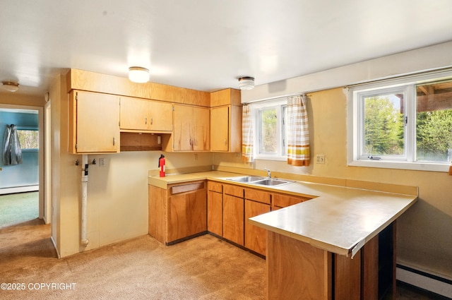 7101 Omalley Rd, Anchorage, AK 99507 - kitchen with a baseboard radiator, a sink, a peninsula, and light carpet