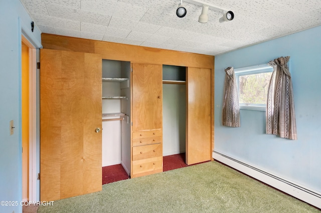 7101 Omalley Rd, Anchorage, AK 99507 - unfurnished bedroom featuring a baseboard heating unit, carpet floors, and a closet