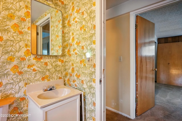 7101 Omalley Rd, Anchorage, AK 99507 - bathroom featuring wallpapered walls, vanity, and baseboards