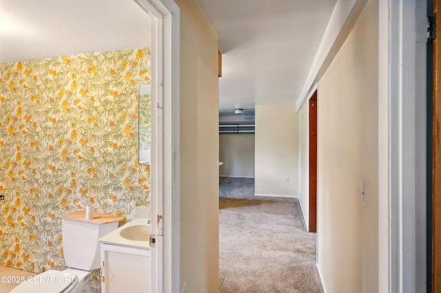 7101 Omalley Rd, Anchorage, AK 99507 - half bathroom featuring vanity, wallpapered walls, toilet, and baseboards