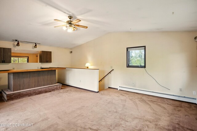 7101 Omalley Rd, Anchorage, AK 99507 - unfurnished living room featuring carpet flooring, vaulted ceiling, baseboard heating, a ceiling fan, and baseboards