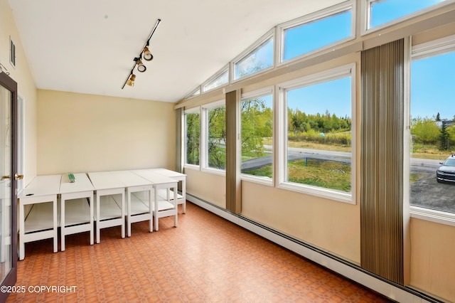 7101 Omalley Rd, Anchorage, AK 99507 - sunroom featuring rail lighting, vaulted ceiling, and a baseboard heating unit