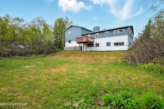7101 Omalley Rd, Anchorage, AK 99507 - back of house with a deck, a chimney, and a lawn