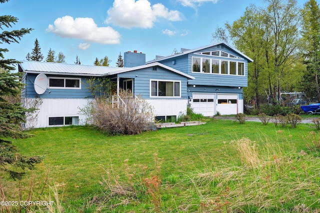 7101 Omalley Rd, Anchorage, AK 99507 - rear view of house with a chimney, a garage, a yard, and metal roof