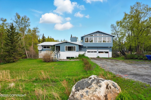 7101 Omalley Rd, Anchorage, AK 99507 - view of front of property with an attached garage, driveway, and a front yard