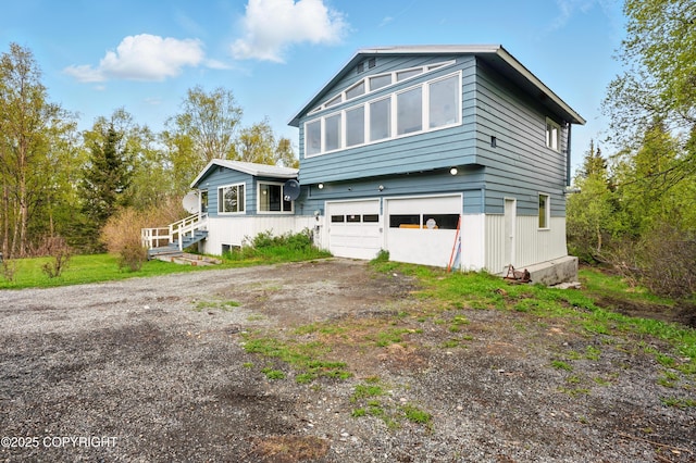 7101 Omalley Rd, Anchorage, AK 99507 - view of front of home featuring dirt driveway and an attached garage