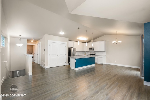 12248 Vista Ridge Loop # 30, Eagle River, AK 99577 - kitchen with stainless steel appliances, vaulted ceiling, a chandelier, white cabinetry, and dark wood-type flooring