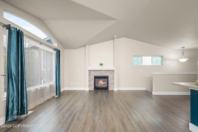 12248 Vista Ridge Loop # 30, Eagle River, AK 99577 - unfurnished living room featuring wood finished floors, vaulted ceiling, and a stone fireplace
