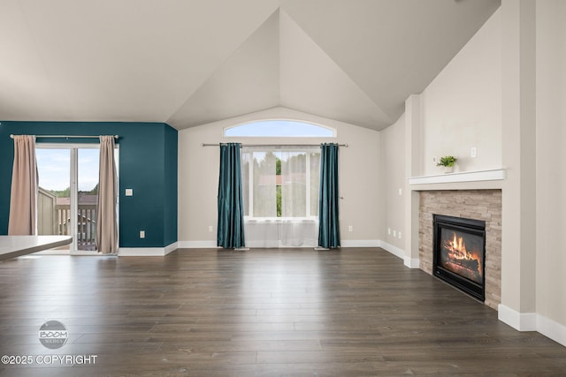 12248 Vista Ridge Loop # 30, Eagle River, AK 99577 - unfurnished living room featuring healthy amount of natural light, a stone fireplace, dark wood-style floors, and vaulted ceiling