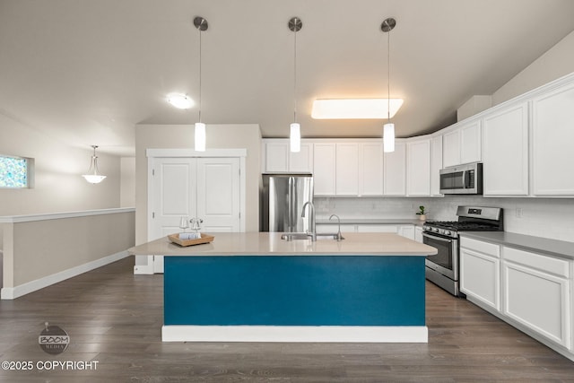 12248 Vista Ridge Loop # 30, Eagle River, AK 99577 - kitchen with appliances with stainless steel finishes, a center island with sink, decorative backsplash, and white cabinetry