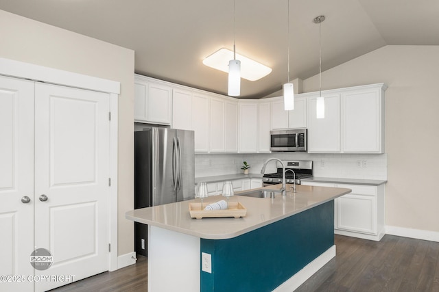 12248 Vista Ridge Loop # 30, Eagle River, AK 99577 - kitchen with stainless steel appliances, vaulted ceiling, tasteful backsplash, dark wood-type flooring, and white cabinetry