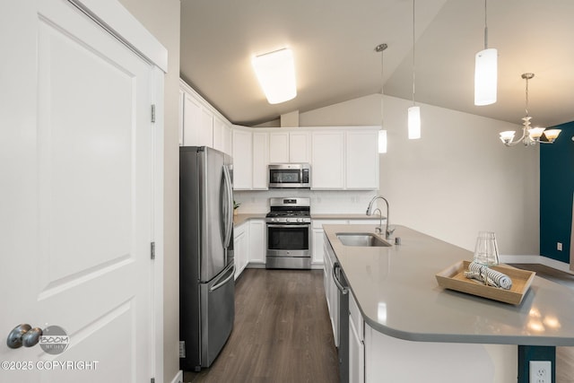 12248 Vista Ridge Loop # 30, Eagle River, AK 99577 - kitchen featuring appliances with stainless steel finishes, lofted ceiling, dark wood-type flooring, and white cabinetry