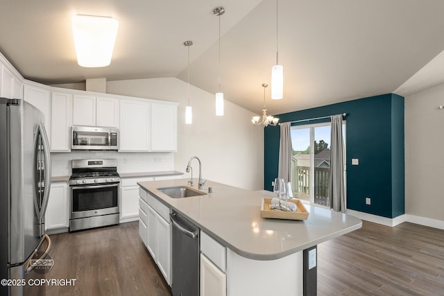 12248 Vista Ridge Loop # 30, Eagle River, AK 99577 - kitchen featuring stainless steel appliances, tasteful backsplash, dark wood-type flooring, white cabinetry, and vaulted ceiling