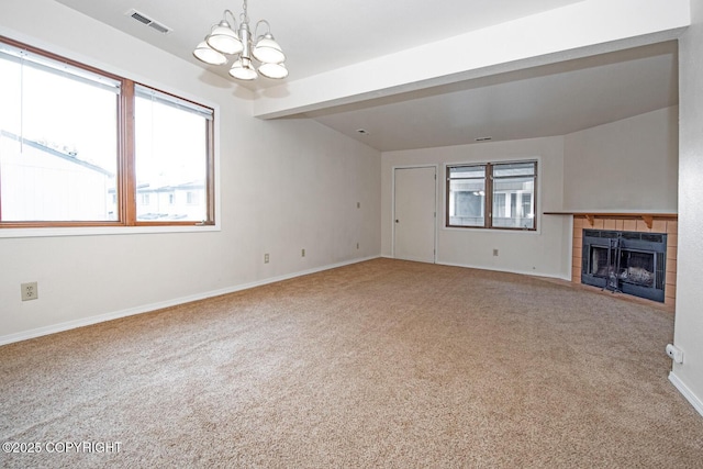 4063 E 20th Ave Unit D54, Anchorage, AK 99508 - unfurnished living room featuring a chandelier, carpet floors, a tile fireplace, baseboards, and beamed ceiling