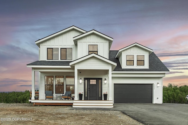 5233 W Jaxton Cir, Wasilla, AK 99623 - view of front of property featuring a porch, driveway, board and batten siding, and roof with shingles