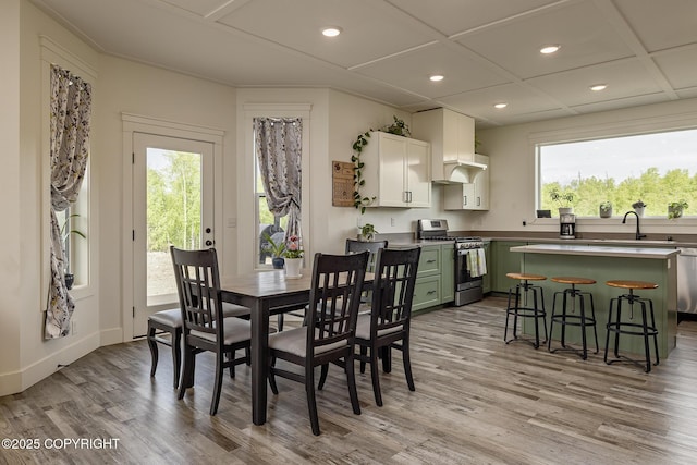5233 W Jaxton Cir, Wasilla, AK 99623 - dining room featuring light wood finished floors, plenty of natural light, recessed lighting, and baseboards