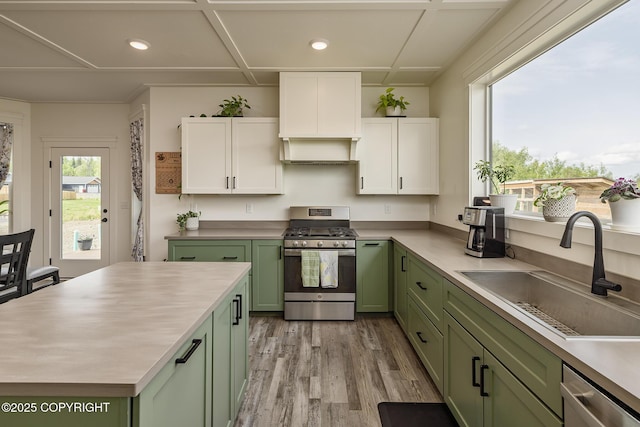 5233 W Jaxton Cir, Wasilla, AK 99623 - kitchen with green cabinetry, stainless steel appliances, a sink, white cabinets, and light wood-type flooring