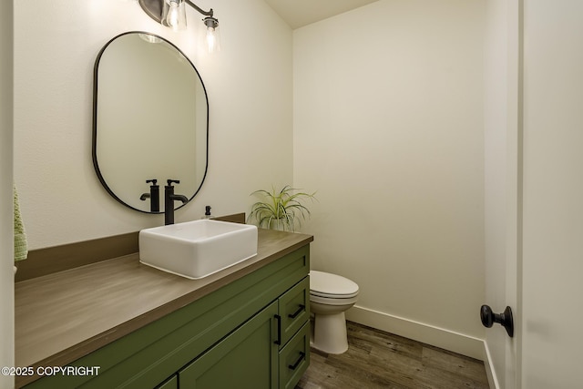 5233 W Jaxton Cir, Wasilla, AK 99623 - bathroom featuring wood finished floors, vanity, toilet, and baseboards