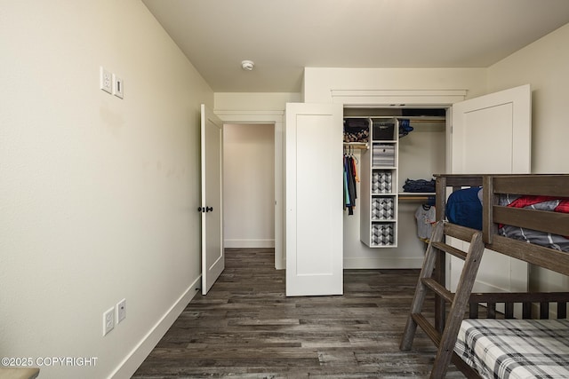 5233 W Jaxton Cir, Wasilla, AK 99623 - bedroom featuring dark wood-type flooring, baseboards, and a closet