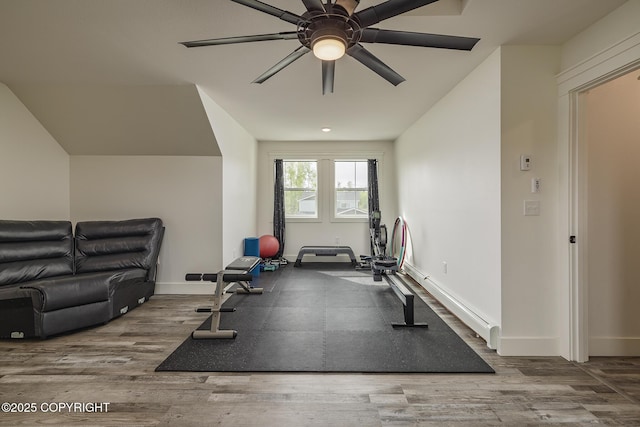 5233 W Jaxton Cir, Wasilla, AK 99623 - workout room featuring a baseboard heating unit, a ceiling fan, wood finished floors, and baseboards