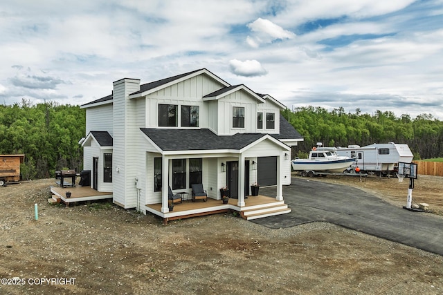 5233 W Jaxton Cir, Wasilla, AK 99623 - view of front facade with board and batten siding, asphalt driveway, a shingled roof, and a wooden deck
