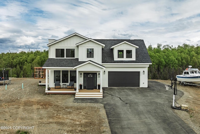 5233 W Jaxton Cir, Wasilla, AK 99623 - modern inspired farmhouse with a trampoline, a garage, driveway, board and batten siding, and a shingled roof