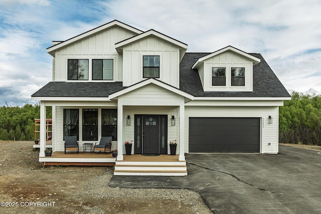5233 W Jaxton Cir, Wasilla, AK 99623 - view of front of property with covered porch, driveway, an attached garage, and a shingled roof