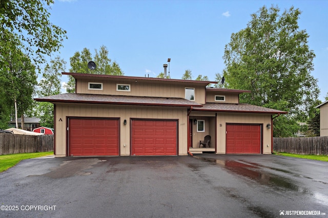 3529 W 41st Ave, Anchorage, AK 99517 - view of front facade featuring asphalt driveway, a garage, and roof with shingles