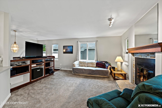 3529 W 41st Ave, Anchorage, AK 99517 - living room featuring a glass covered fireplace, carpet flooring, baseboards, and baseboard heating