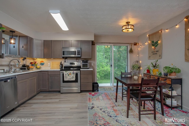 767 N Yakima St, Wasilla, AK 99654 - kitchen featuring stainless steel appliances, light wood finished floors, and light countertops